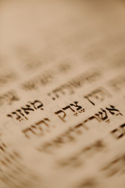 A detailed close-up of Hebrew text on a traditional religious document, emphasizing cultural significance.